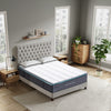 Bedroom with a tufted headboard and a mattress on a bed